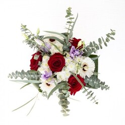 Imagined and arranged with the care unique to Malden Rushett Florist, this bouquet embodies quiet confidence and refined artistry. Generous white gerberas, their petals radiating lithely from espresso-hued centers, pair harmoniously with classic red roses-the spiraled blooms evoking enduring affection and the joy of village celebrations. Wisps of eucalyptus, silver-toned and aromatic, rise above the arrangement with gentle energy, echoing the breezy hedgerows of nearby rural lanes. Lisianthus in shades of lilac are scattered thoughtfully throughout, some in bud, weaving a contemporary softness through the bouquet. Down below, broad, polished green leaves enclose the stems, offering a grounding structure while plumes of small white filler flowers billow upward, reminiscent of spring clouds over the peaceful Surrey landscape. The fragrance-a delicate marriage of eucalyptus and rose-invites moments of reflection. Whether presented to mark an anniversary, send comfort, or brighten a cozy home on Rushett Drive, this arrangement captures the enduring trust and artistry found at Malden Rushett Florist.