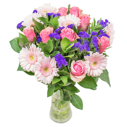 Inspired by the peaceful lanes and green expanses of Malden Rushett, this arrangement celebrates the poetic interplay between blush gerberas and classic pink roses. Each flower is selected for its luminous petals, blending gentle shades in a subtle gradient akin to the shifting colours seen at sunrise over Rushett Woods. Deep purple statice adds joyful punctuation, their vivid tones offering contrast and a touch of wild charm reminiscent of local bridle paths. The fresh, dewy greenery cradles the blooms, its cooling touch grounding the airy, uplifting cluster above-a sensory nod to mornings spent in the community's open fields. Set in an understated glass vase, the entire palette glows softly in the light, inviting a sense of warmth and optimism into any space. Ideal as a cheerful get well, an elegant accent for a sunlit Malden Rushett kitchen, or a stylish way to mark special moments, this bouquet embodies expert floristry and local spirit, crafted to share joy with every recipient.